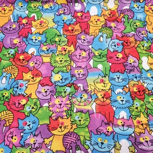 May include: A colorful fabric with a repeating pattern of cartoon cats. The cats are drawn in a variety of colors, including blue, green, red, yellow, and purple. They are all smiling and have different expressions.