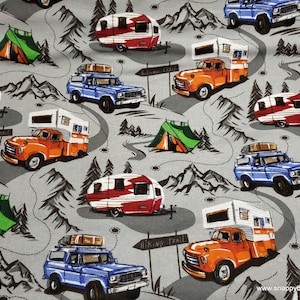 May include: A gray and white fabric with a repeating pattern of vintage campers, trucks, and tents. The pattern is set against a gray background with a subtle texture. The campers and trucks are in various shades of blue, red, orange, and white. The tents are green and white. The pattern includes the text "Hiking Trail".