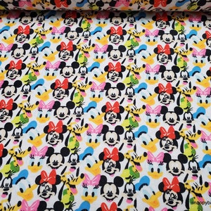 May include: White fabric with a repeating pattern of colorful cartoon faces of Mickey Mouse, Minnie Mouse, Donald Duck, and Goofy.