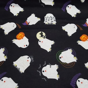 May include: Black fabric with a white ghost pattern. The ghosts are repeated throughout the fabric and are surrounded by Halloween themed elements like bats, pumpkins, and spiders.