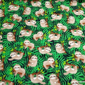 May include: A green and brown fabric with a repeating pattern of sloths hanging from branches in a jungle setting.