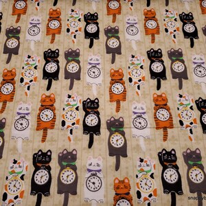 May include: A beige fabric with a repeating pattern of black, white, orange, and gray cats holding clocks. The cats are in various poses, some are sitting, some are standing, and some are hanging from the clock. The clocks are all different shapes and sizes, and some have Roman numerals.