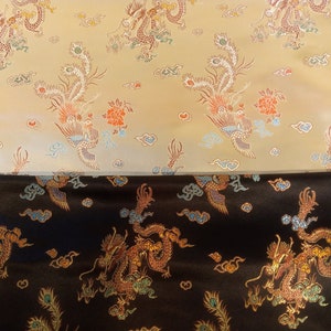 May include: Two fabrics with an ornate dragon and phoenix pattern. The top fabric is a light tan color, and the bottom fabric is black. The design features dragons, phoenixes, clouds, and flowers in shades of red, orange, blue, and gold.