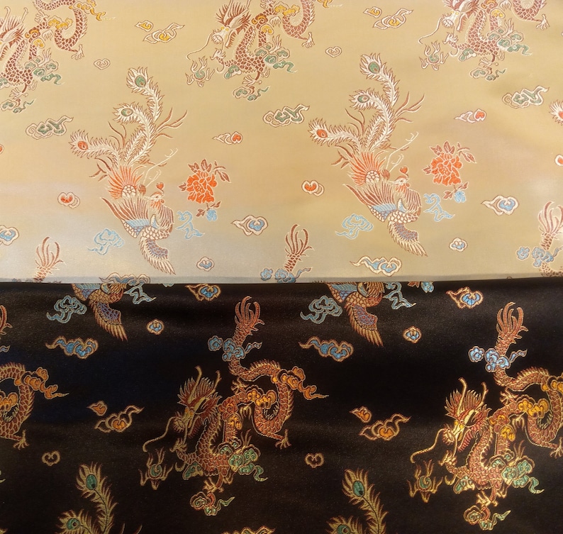 May include: Two fabrics with an ornate dragon and phoenix pattern. The top fabric is a light tan color, and the bottom fabric is black. The design features dragons, phoenixes, clouds, and flowers in shades of red, orange, blue, and gold.