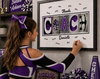 May include: A framed wall art print featuring the word COACH in large letters, with the letter O replaced by a purple pom-pom and the letter H featuring a cheerleader silhouette. The print includes the text Thanks and Danielle with names.
