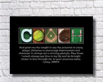 May include: A black rectangular print featuring the word COACH spelled with sports imagery: a white C, a yellow softball, a baseball diamond, a brown glove, and two pink bats forming the H. Below is a prayer text in white font.
