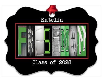 May include: A black, scalloped-edge ornament featuring the name Katelin and the text Class of 2028. The center displays the name FISHMAN spelled out using photographic letters depicting a green letter F, a black and white grill, a white volleyball, a green number 5, a white basketball hoop, a green letter M, and a green shoe with white laces.