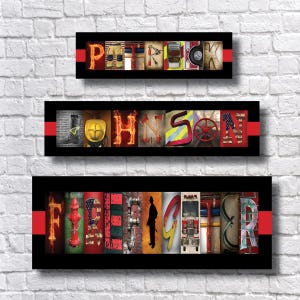 May include: Three black framed signs with red borders, each with a different name spelled out in colorful letters made from images of fire trucks, fire hydrants, and other firefighting equipment. The names are "Patrick", "Johnson", and "Firefighter".