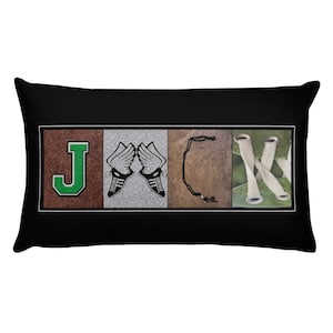 May include: A black and white pillow with the word "JACK" spelled out using images of a green letter J, a pair of running shoes with wings, a brown letter C, and a green letter K.
