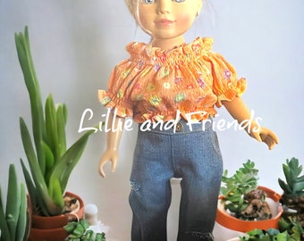 May include: A doll with blonde hair wearing an orange floral top and blue jeans. The doll is surrounded by small potted plants. The text "Lillie and Friends" is visible on the image.