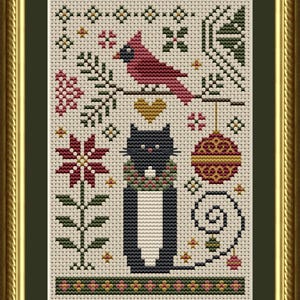 May include: A cross-stitch embroidery featuring a black cat wearing a wreath, a red cardinal on a branch, a gold heart, a red and gold ornament, and a poinsettia flower. The design is set against a cream-coloured fabric background and framed.