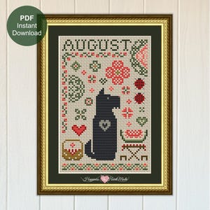 May include: A framed cross-stitch pattern featuring the text AUGUST at the top, a central black dog silhouette with a heart on its chest, surrounded by small motifs including ladybugs, hearts, a basket, and a watermelon slice in red and green.
