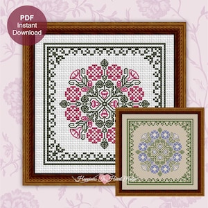 May include: A cross stitch pattern featuring two framed designs. The larger design has a white background with a central floral motif in pink and dark green, surrounded by a geometric border. The smaller design has a beige background with blue flowers.
