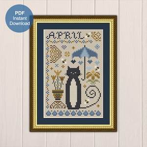 Könnte beinhalten: Kreuzstichmuster mit einer schwarzen Katze mit eingerolltem Schwanz, einem blauen Regenschirm und gelben Blumen. Das Muster ist mit "APRIL" betitelt und in Gold gerahmt.