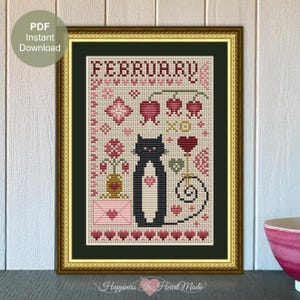 Può includere: Schema di ricamo a punto croce con un gatto nero con petto e coda bianchi, circondato da cuori, fiori e la parola "Febbraio".
