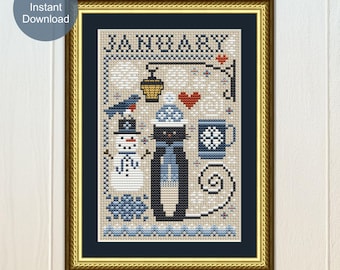 May include: A cross-stitch pattern titled JANUARY featuring a black cat wearing a blue hat and scarf, a snowman, a bird, a mug, and a lantern. The design uses a palette of blue, white, black, and red on a beige background, framed in a gold-toned frame.