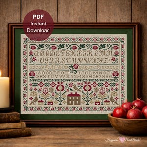 May include: Framed cross-stitch sampler with a green border, featuring an alphabet, numbers, and floral and bird motifs in red, green, and tan. The words "PDF Instant Download" are in a circular maroon graphic.
