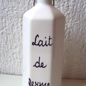 White stoneware milk bottle.