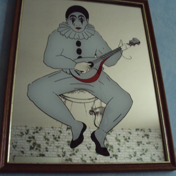 Miroir représentant un pierrot jouant de la guitare datant des années 1970.