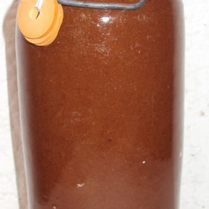 Brown stoneware hot water bottle or bottle dating from the 1950s.
