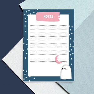 May include: A blue and white printable notepad with a ghost and crescent moon design. The notepad has the word "NOTES" at the top.