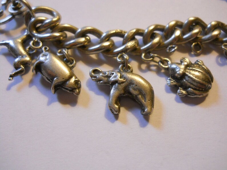 Silver Charm Bracelet 0.900 Vintage Heavy and Solid old world traveler charm bracelet elephant more charms Kewpie Unusual Clasp frog