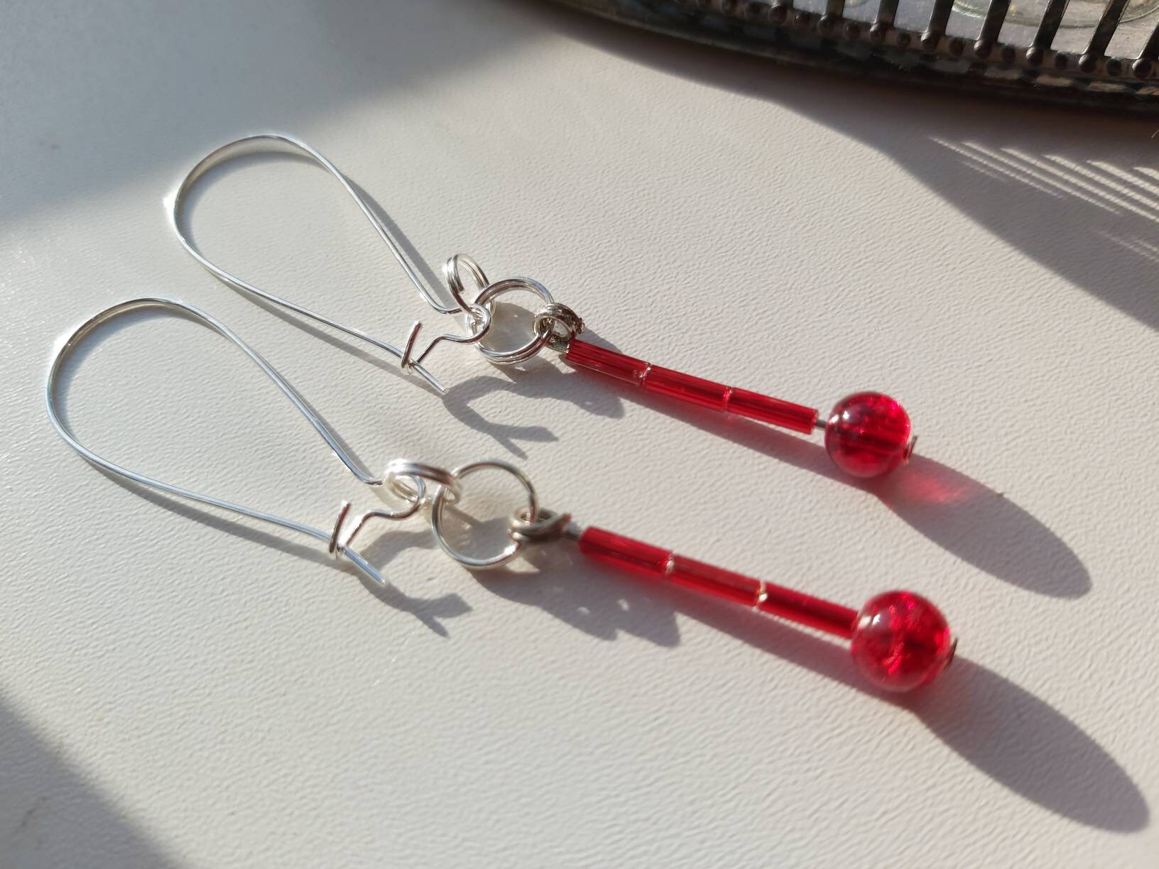 Blood drop earrings. Red beads hung on wires that fit through Etsy