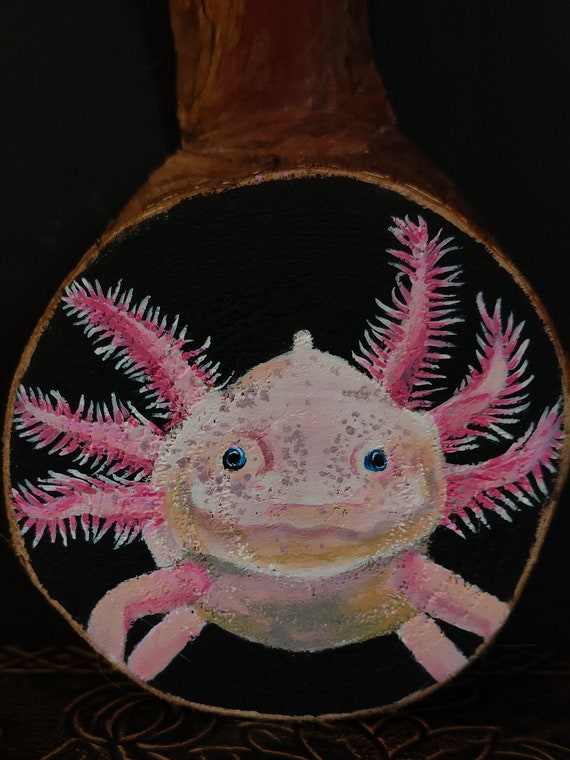 An axolotl — the internet's favorite salamander — painted in acrylics on a wood slice; charming, original, and genuinely handmade.
