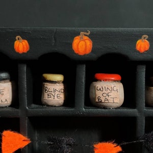 Miniature Halloween dresser with handmade items. Dolls house, pumpkins, bunting