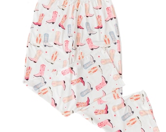 May include: White pajama pants with a pattern of colorful cowboy boots.