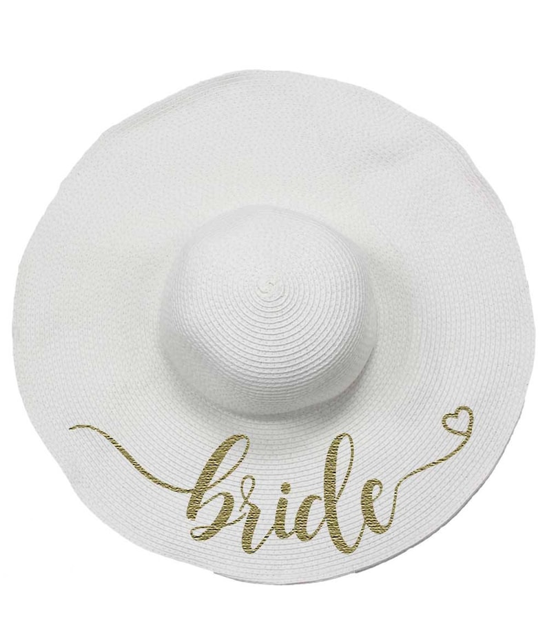 May include: White sun hat with a gold glitter "bride" inscription and a small heart.