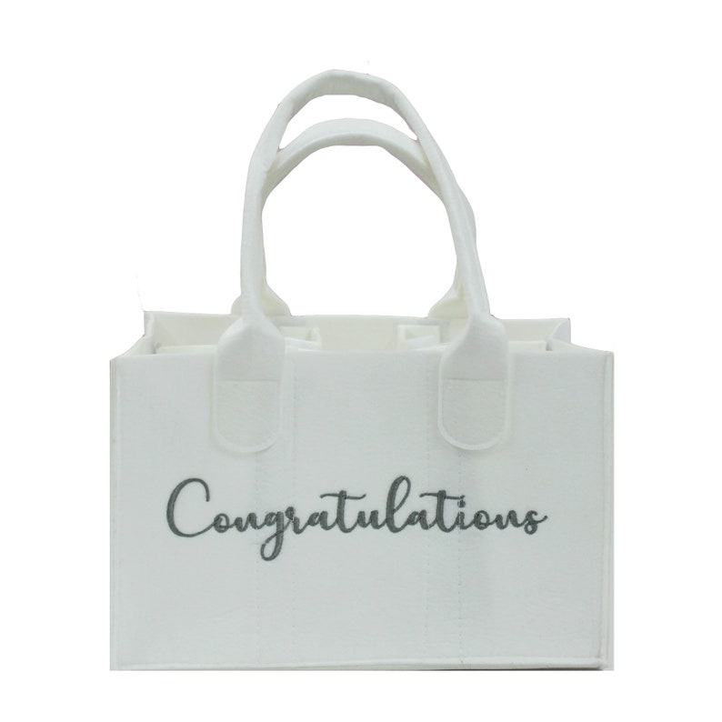 May include: White felt tote bag with two handles and the word "Congratulations" printed in gray on the front.