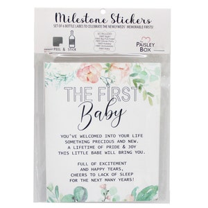 May include: A set of 6 bottle labels with a watercolor floral design. The labels are for a new baby and say "The First Baby". The text reads "You've welcomed into your life something precious and new. A lifetime of pride & joy this little babe will bring you. Full of excitement and happy tears, cheers to lack of sleep for the next many years!"