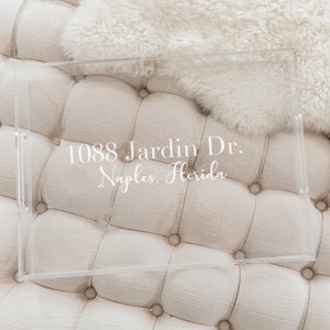 May include: A clear acrylic tray with the text "1088 Jardin Dr. Naples, Florida" printed on it.