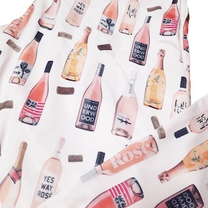 May include: A white background with a repeating pattern of pink wine bottles. The bottles have various labels with text such as "Yes Way Rose", "Love Drunk", "Underwood", and "Chloe".