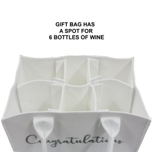 May include: White felt gift bag with six individual compartments for wine bottles. The bag has two handles and the word "Congratulations" printed on the front.