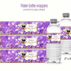 May include: Three purple and gold water bottle labels with a crown and a baby girl illustration. The labels read "Sophie's Baby Shower 1.2.2019". The labels are 9 inches by 2 inches.