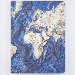 May include: A blue and beige world map notebook with a 3D embossed effect. The map shows the continents and oceans of the world.