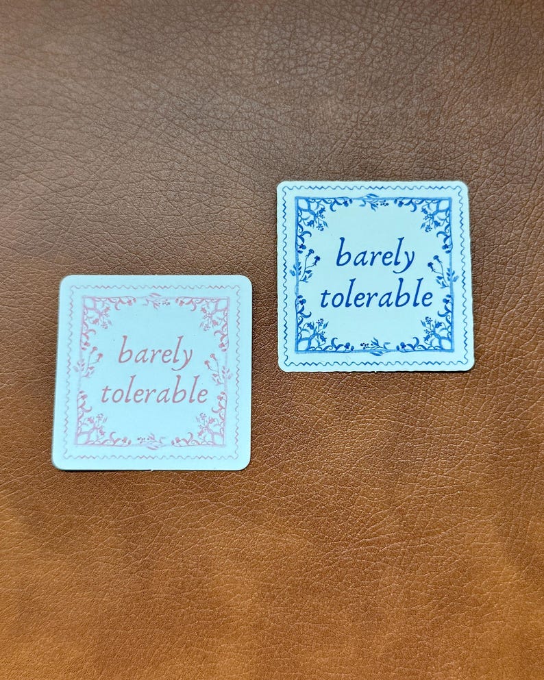 May include: Two square white cards with decorative borders. The top card has a blue border and the text "barely tolerable" in blue. The bottom card has a pink border and the text "barely tolerable" in pink.