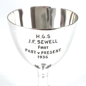 May include: Silver cup trophy with the inscription "H.G.S J.F. SEWELL FIRST PAST V PRESENT 1936"