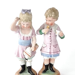Pair of Figurines, Antique Bisque, Young Children, Traditional Poses, Pink Dress, Elegant Additions, German Ceramics, Victorian Figures