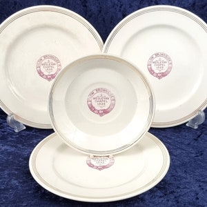 May include: Set of four white ceramic plates with gold trim and a pink inscription that reads "Low Browside Wesleyan Chapel 1895".