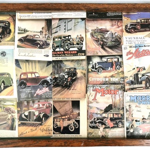 May include: A wooden tray filled with vintage magazine clippings featuring advertisements for various car models, including the Hillman Wizard, Austin Seven, Citroen Ten, and Vauxhall. The tray is decorated with a brown wooden frame and metal handles.