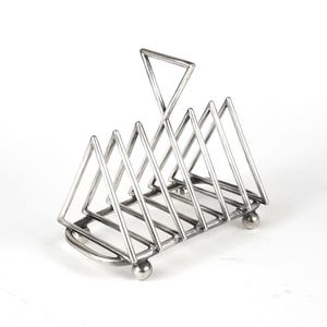 May include: A silver-colored metal toast rack with a triangular design. The rack has a handle and is supported by small, round feet. The design features multiple triangular slots for holding toast slices upright.