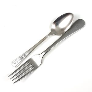 May include: A silver spoon and fork set against a white background. The spoon has a floral design on the handle and the letters "NSN". The fork is stamped with the letters "USN".