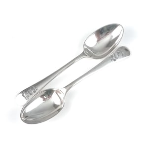 May include: Two silver spoons with the inscription "Hollands" on the handle.