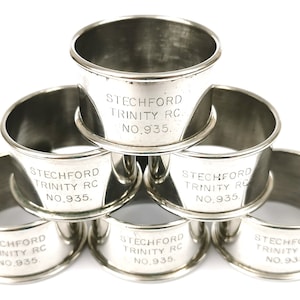 May include: Six silver napkin rings inscribed with "STECHFORD TRINITY RC. NO.935."