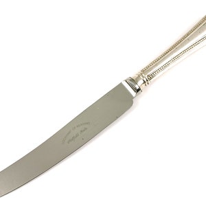 Puede incluir: Un cuchillo de mantequilla de plata con mango de cuentas y la inscripción "The Duke of Reading Sheffield Made" en la hoja.
