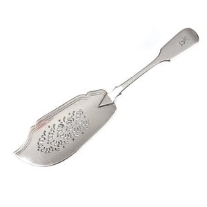 May include: A silver serving spoon with a pierced, decorative design on the front and a handle with the letter "H" engraved on it.