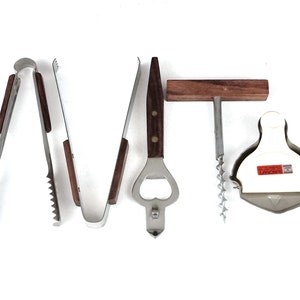 May include: A set of six stainless steel bar tools with wooden handles. The tools include a bottle opener, a corkscrew, a pair of tongs, and a lime squeezer.